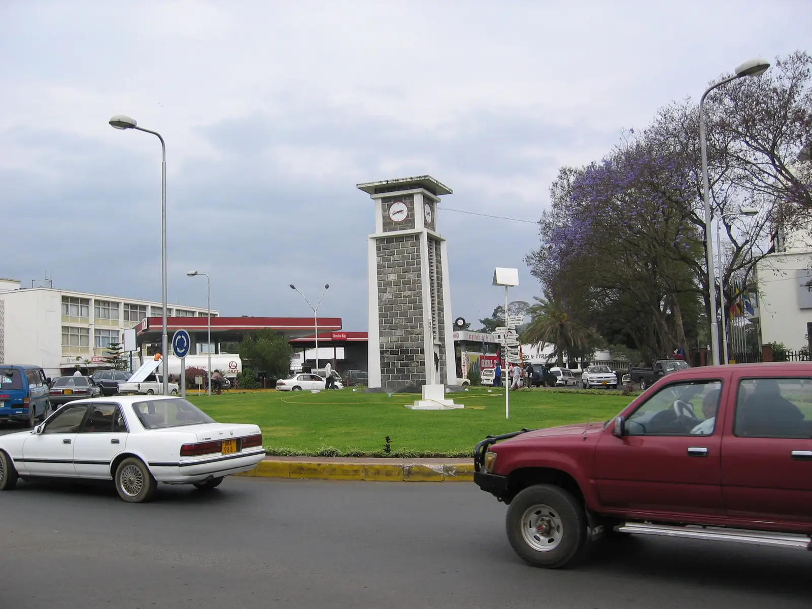 The Arusha Clock Tower on its grassy roundabout, with traffic passing