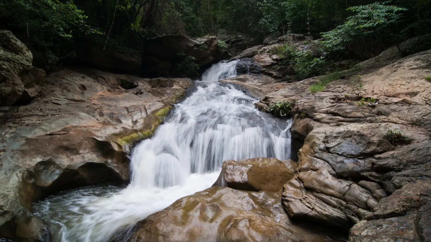 Water pouring over smooth rock at Mae Sa Waterfall