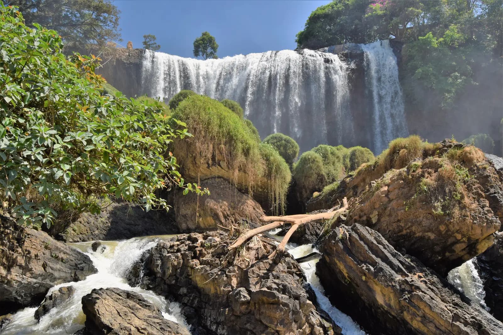 Elephant Falls pouring over a wide rock ledge into a rocky gorge