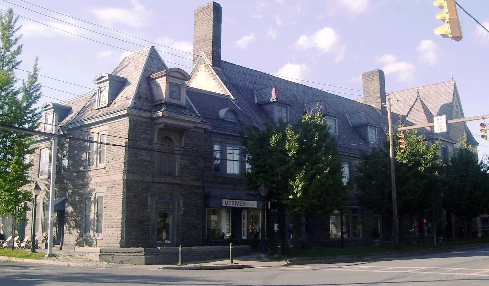 Forest Hall, a grey stone Victorian building on a street corner in Milford