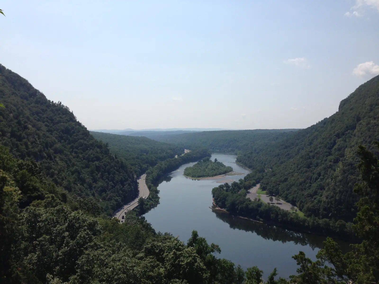 The Delaware River winding between forested mountains through the Delaware Water Gap, seen from the Mount Tammany trail