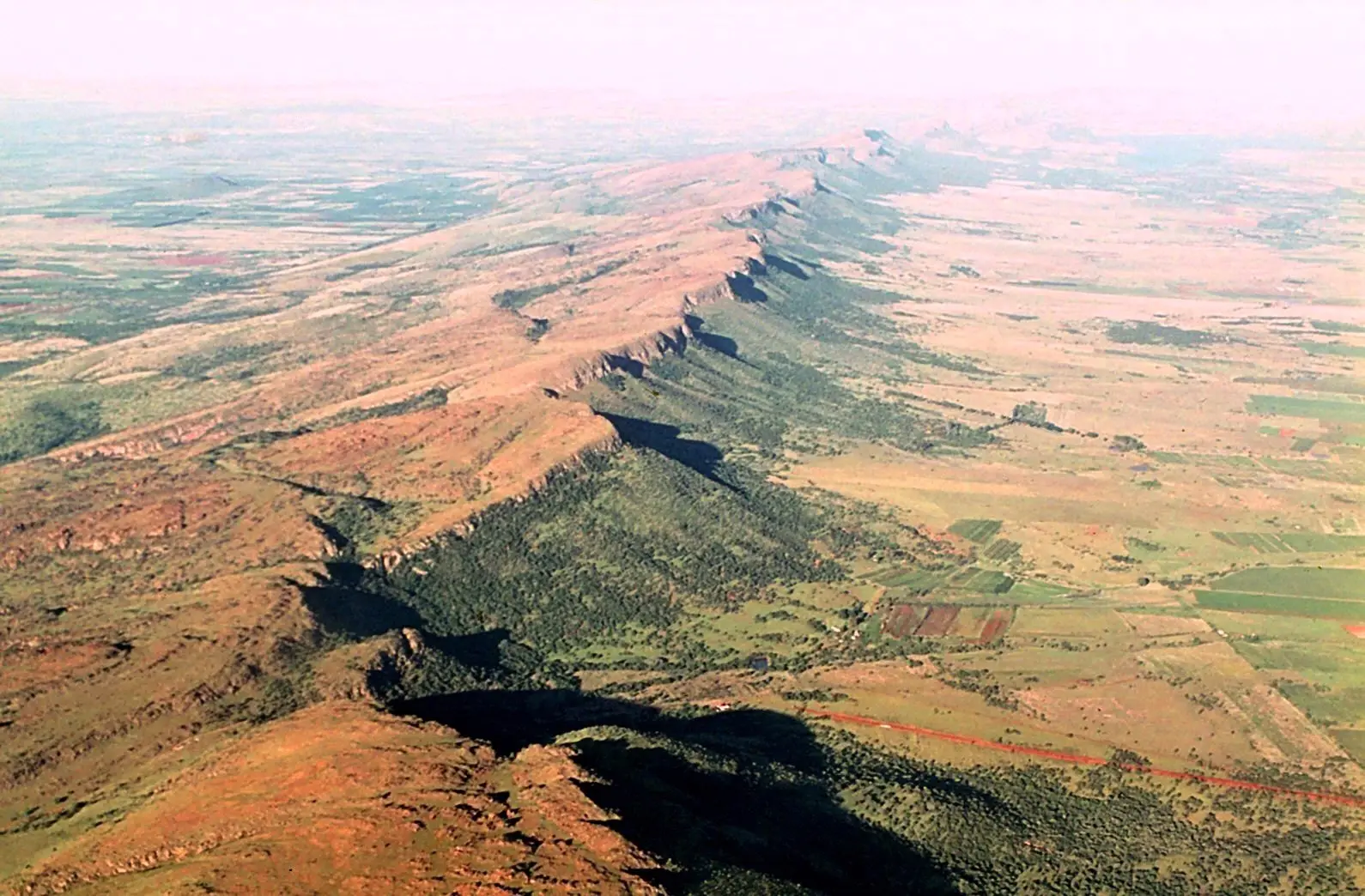 Aerial view of the long Magaliesberg ridge running east towards Hartbeespoort, with farmland in the valley below