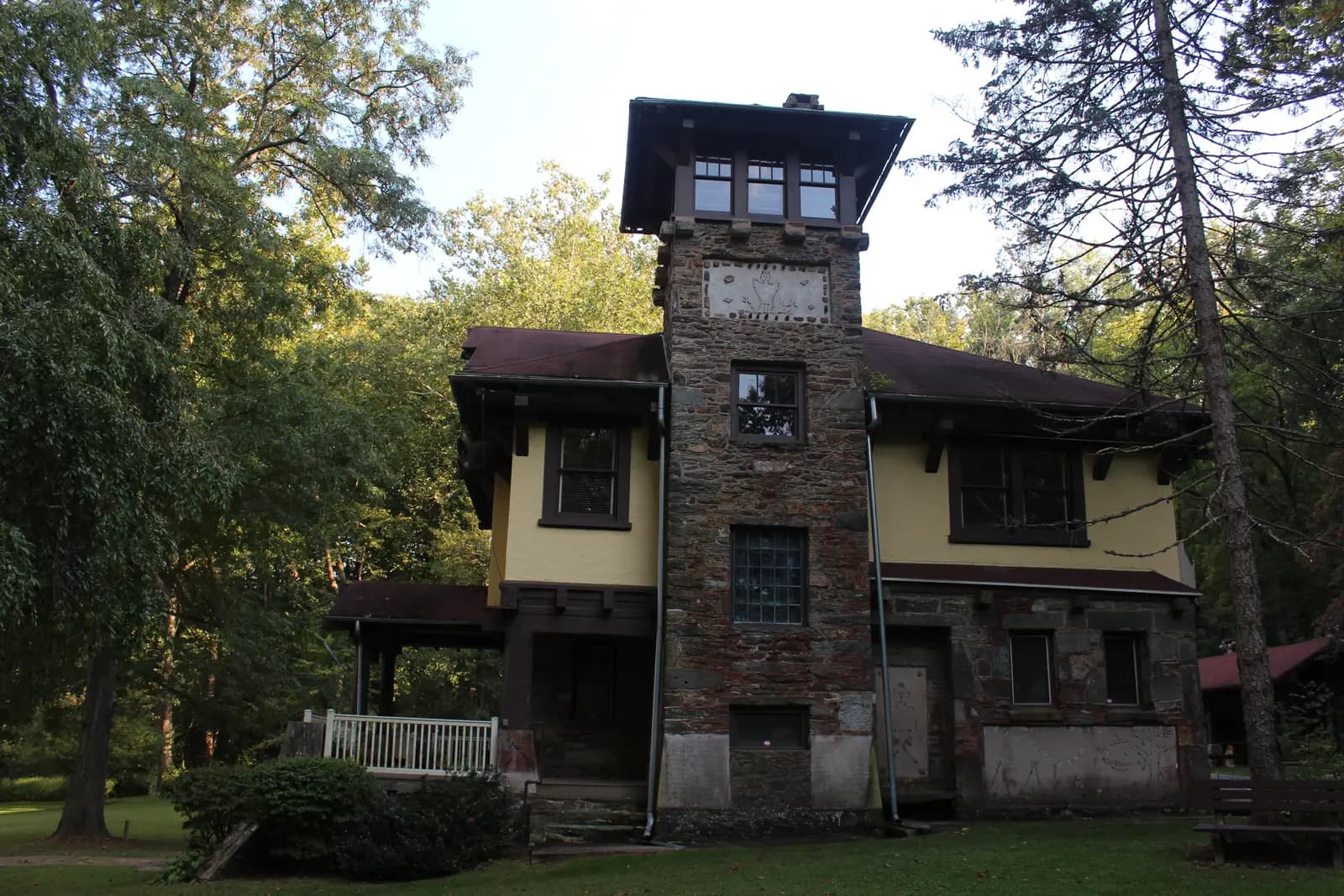 The Indian Steps Museum, a Craftsman-style house with a stone tower, among trees