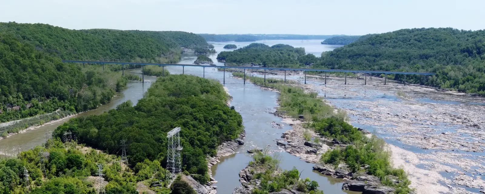 Aerial view of the Norman Wood Bridge crossing the rocky, island-strewn Susquehanna between wooded hills