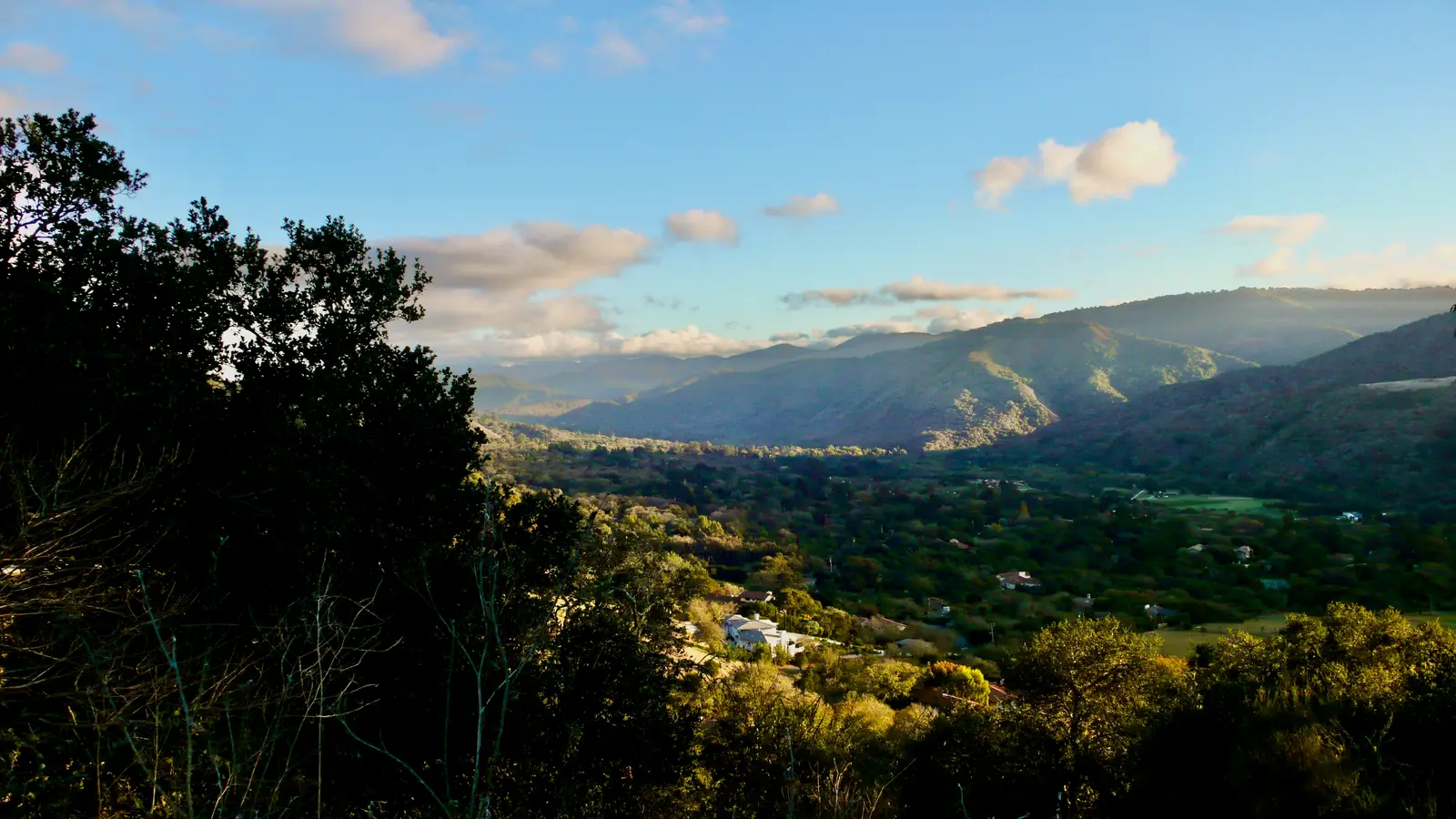 Carmel Valley seen from the oak-covered hills on its north side, with mountains behind