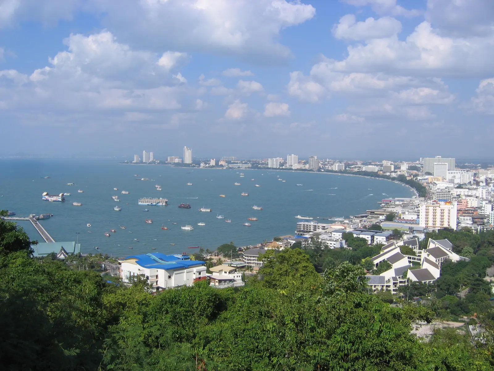 Pattaya Bay with boats at anchor and the city along the shore, seen from Khao Phra Tamnak