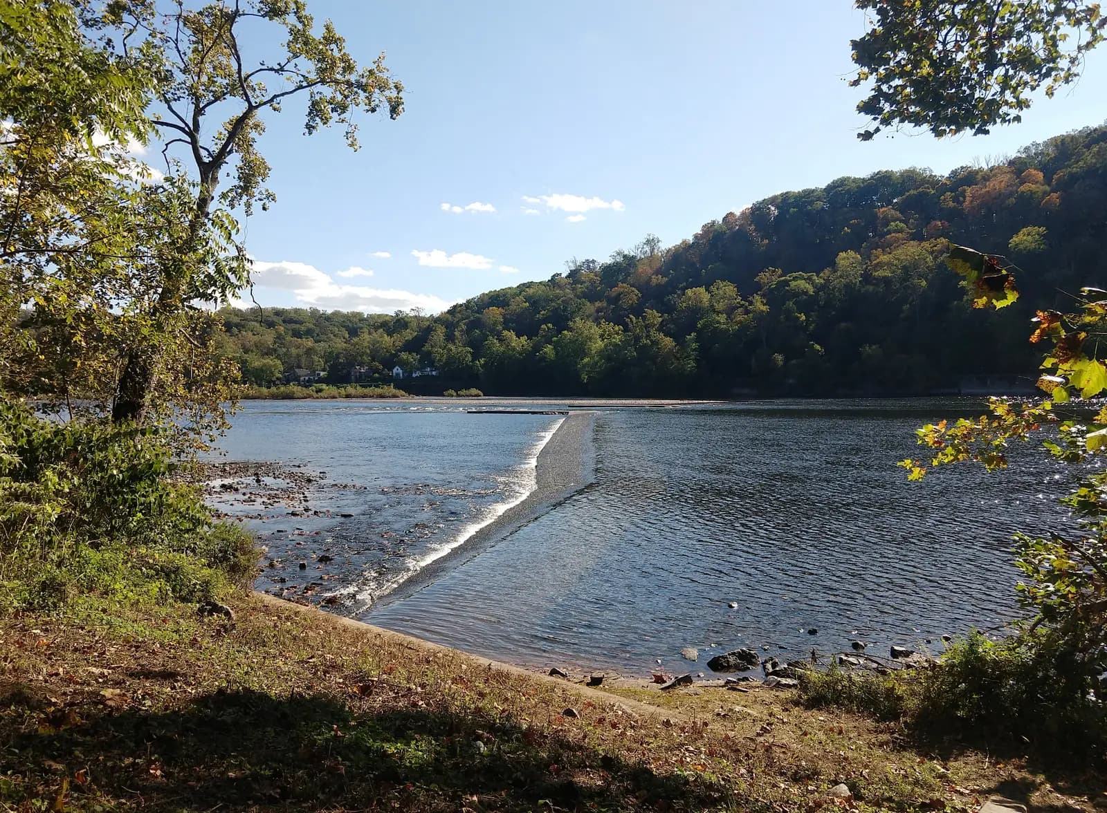 The Delaware River at Bulls Island, with a low stone wing dam running across the water towards wooded hills