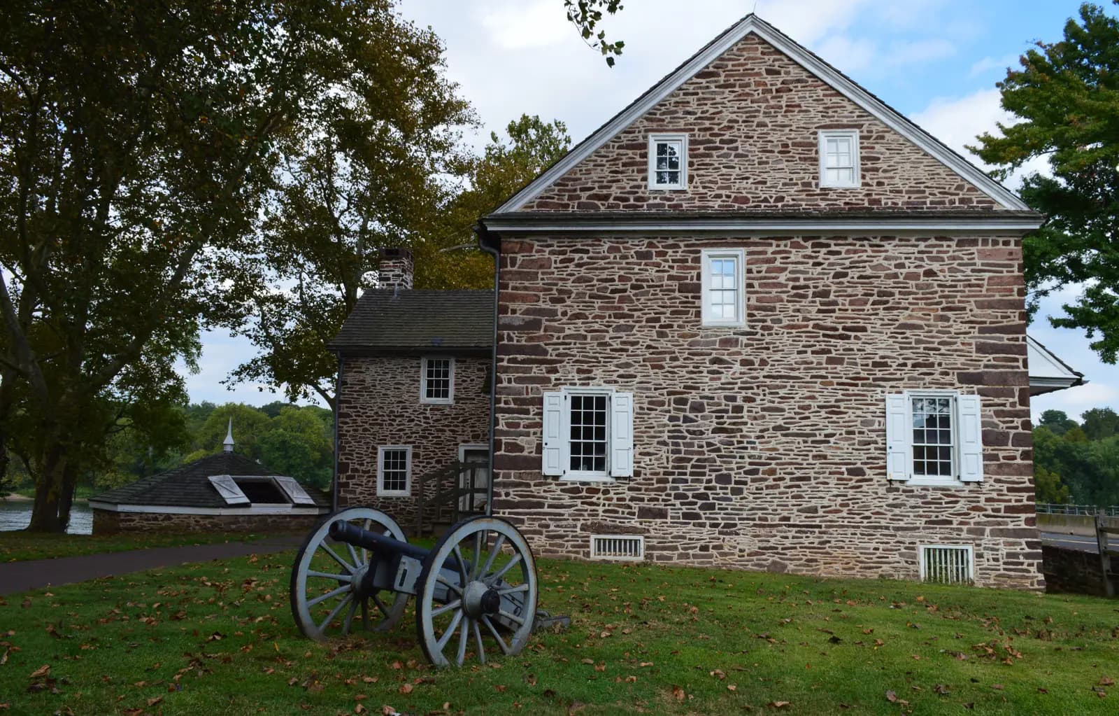 McConkey's Ferry Inn, a two-storey fieldstone house, with a field cannon on the lawn in front