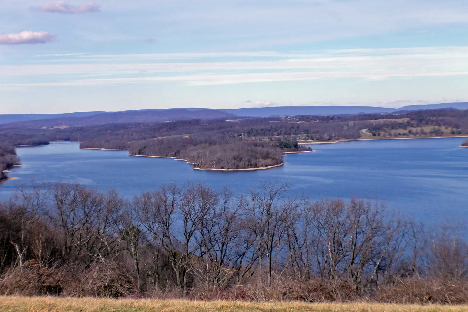 Blue Marsh Lake spreading between wooded shores, with low ridges on the horizon