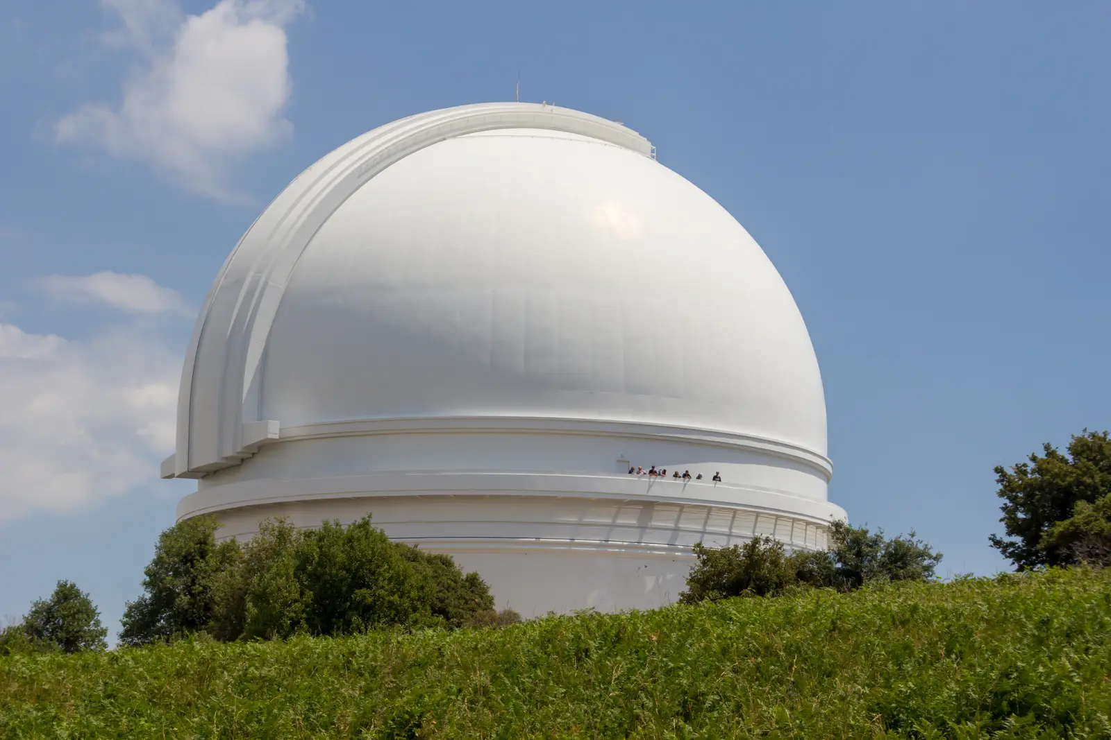 The white dome of the Hale Telescope at Palomar Observatory against a summer sky
