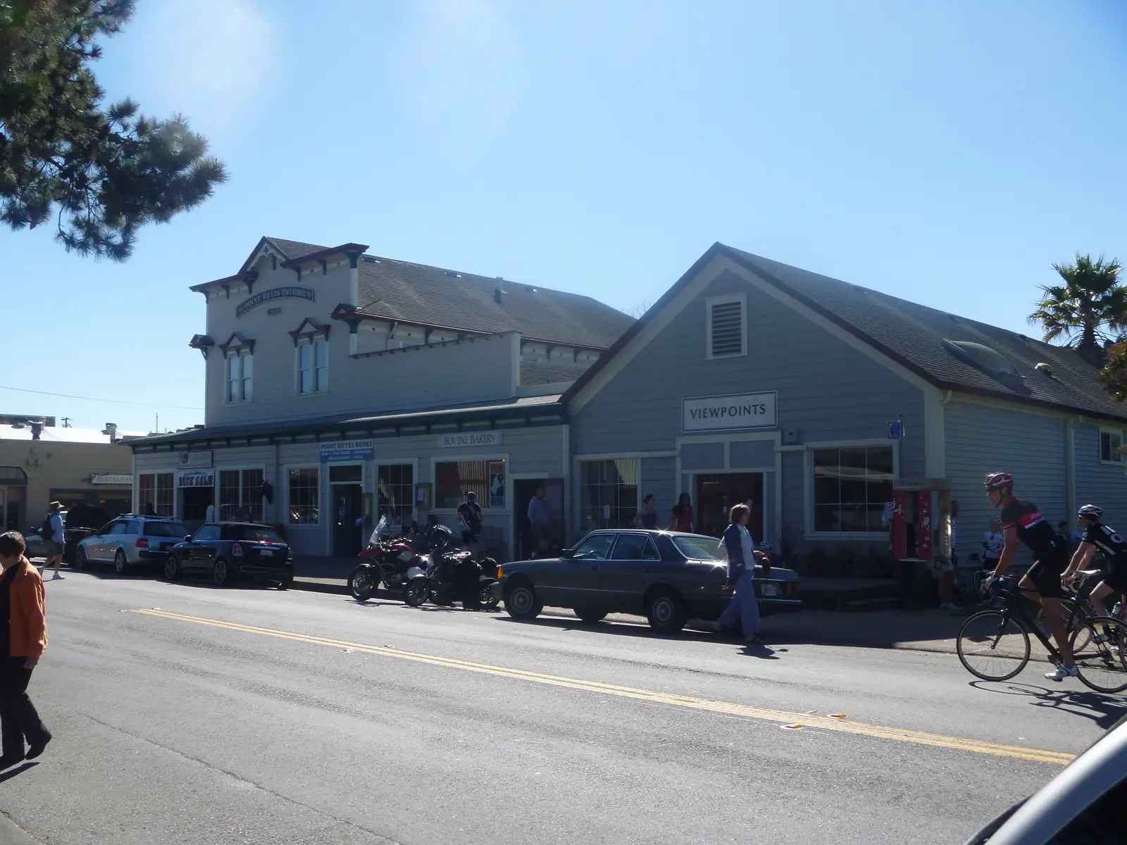Motorcycles and bicycles outside the timber storefronts on the main street of Point Reyes Station