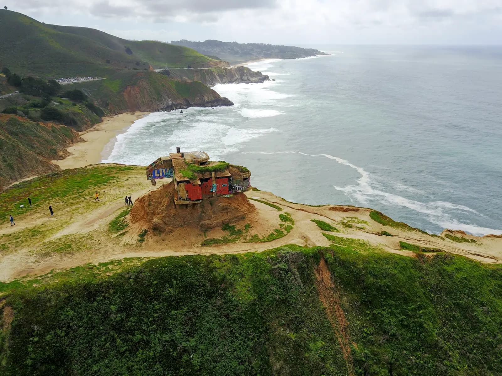 Aerial view of the concrete bunker on the Devil's Slide headland, with the coastline running south behind it