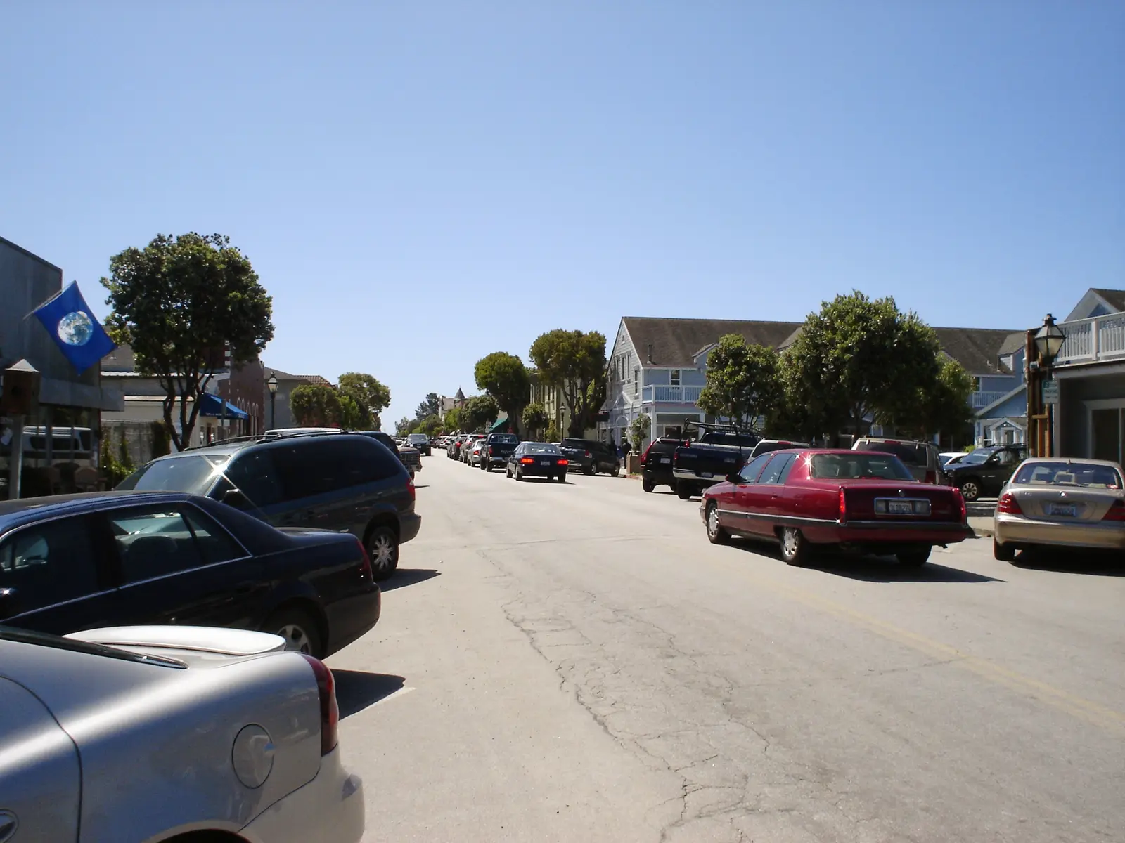 Main Street in Half Moon Bay with parked cars and two-storey timber buildings