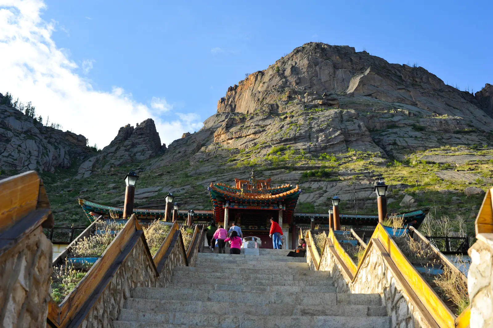 Steps leading up to the gate of Aryabal Meditation Temple below a granite peak