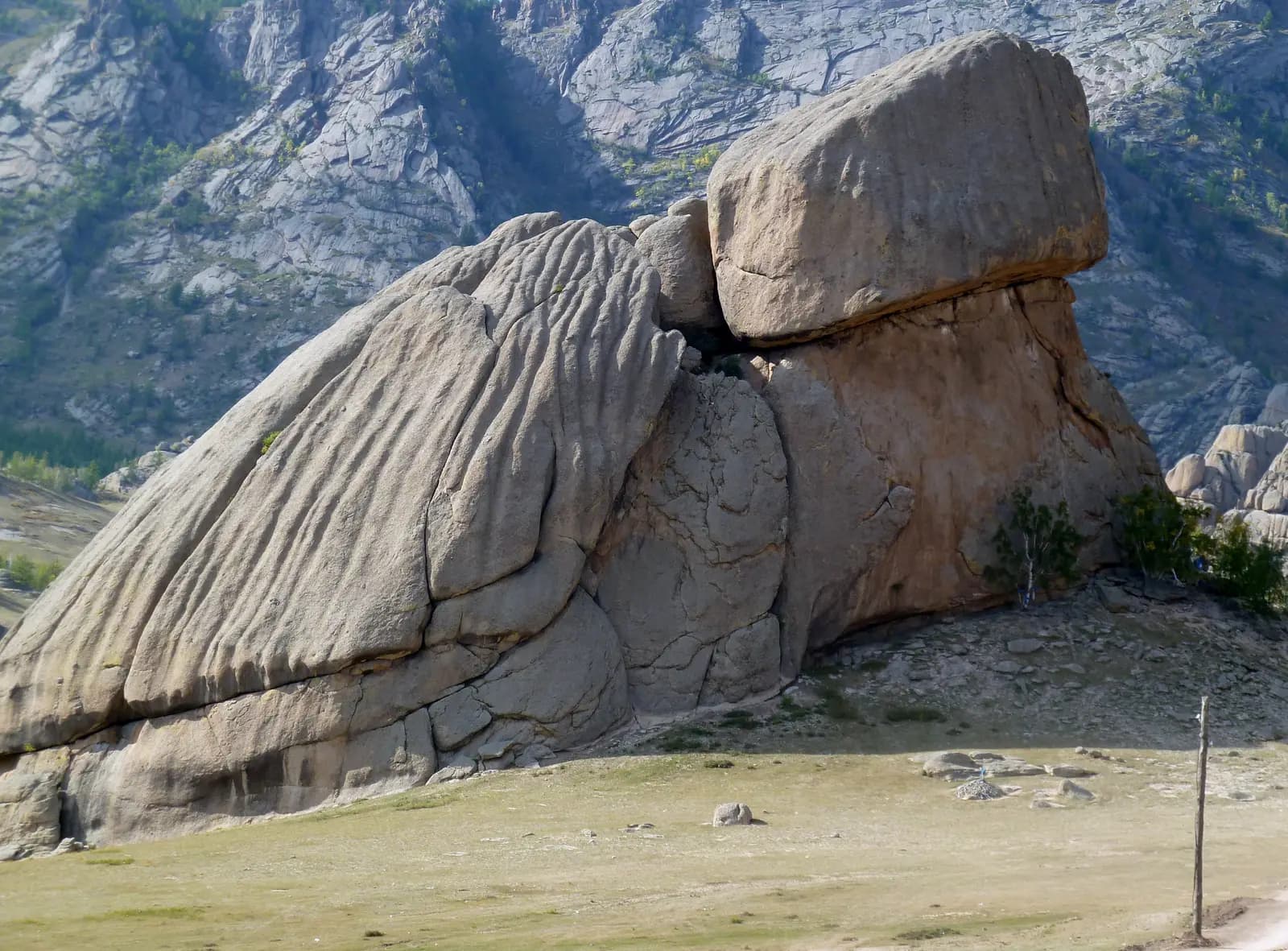 Turtle Rock, a huge granite boulder shaped like a turtle, with rocky hills behind