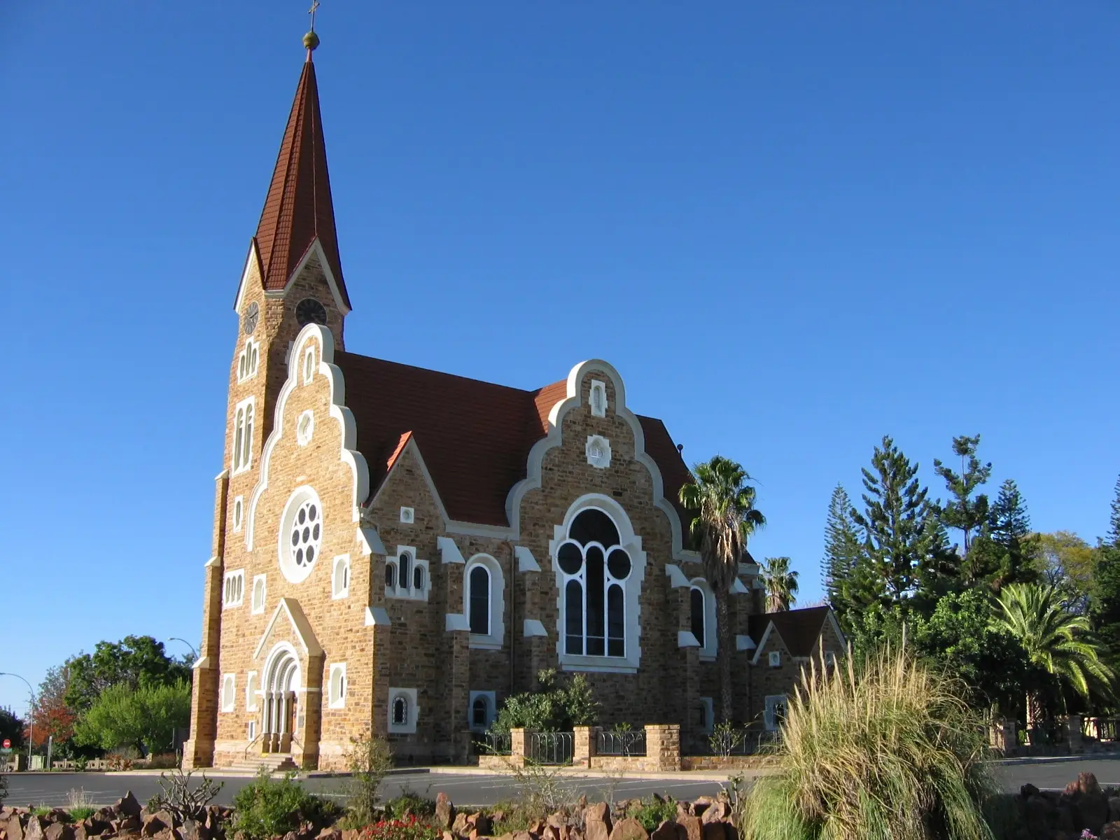 The sandstone Christuskirche in Windhoek with its red steeple against a blue sky